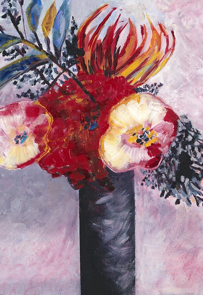 Vibrant still life of a red waratah surrounded by cream and pink poppy-like blooms, gum leaves and banksia foliage in a dark cylindrical vase.