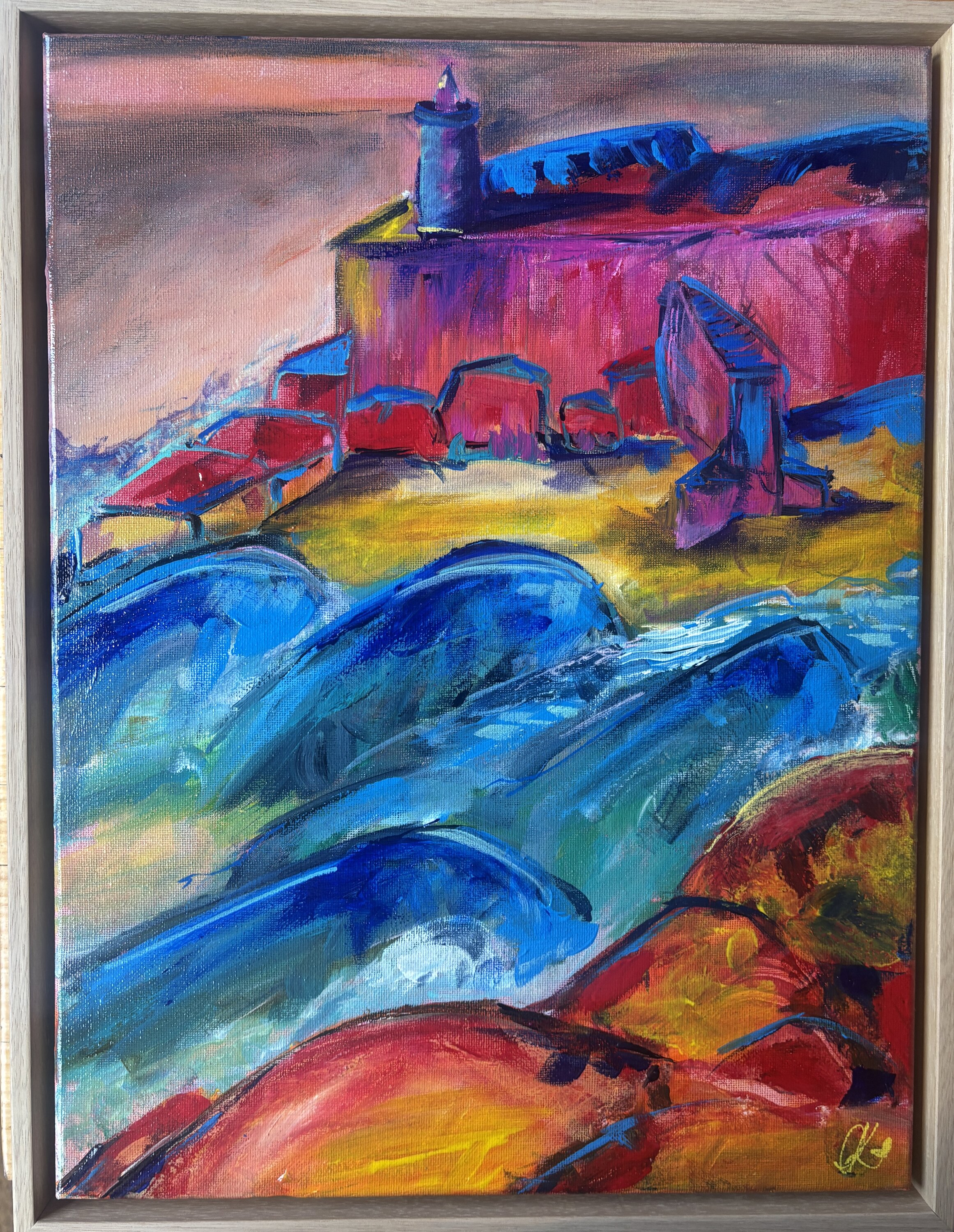 Expressionist seascape of churning blue waves with white foam rolling onto a yellow shore, beneath a deep blue and crimson coastal village against a pink and orange sky.